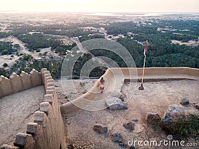 Woman enjoying sunset view from Dhayah fort in the UAE Stock Photo