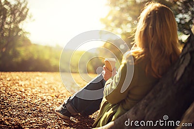 Woman enjoying takeaway coffee cup on sunny cold fall day Stock Photo