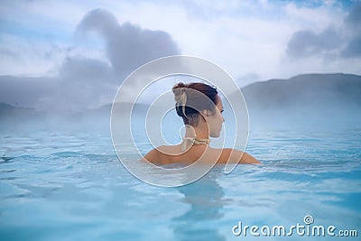 Woman enjoys spa in geothermal hot spring Stock Photo