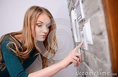 The woman entering code into the keypad Stock Photo
