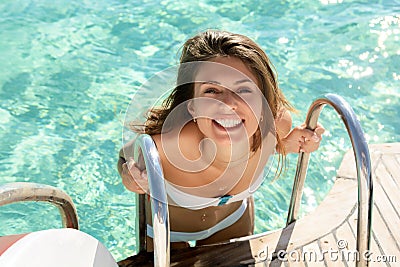 Woman entering pool Stock Photo