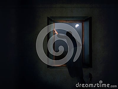 Woman escaping through window. Stock Photo