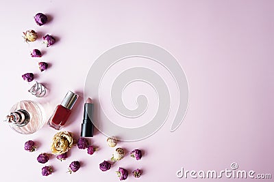 Woman essential accessory Flat lay . on pink pastel background .Top view copy space, lipstick, perfume , roses Stock Photo