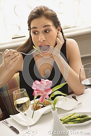 Woman exaggerating eating. Stock Photo