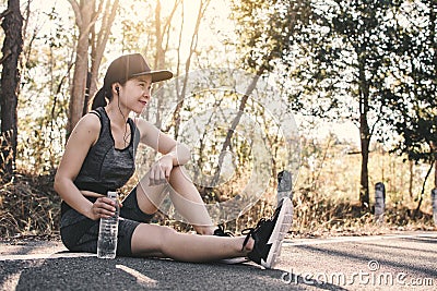 Woman exercise and rest on road Stock Photo