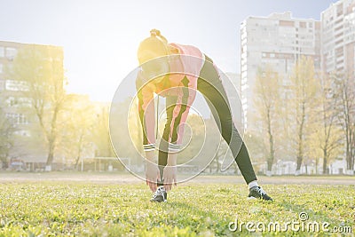 Woman goes sports leaning to the foot Stock Photo