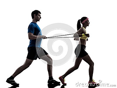 Woman exercising fitness resistance rubber band with man coach Stock Photo