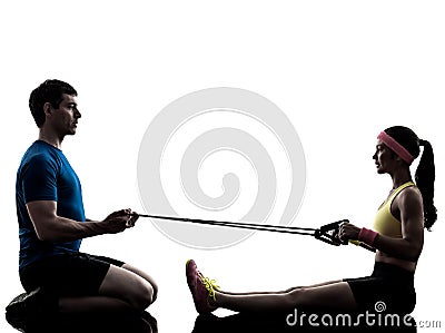 Woman exercising fitness resistance rubber band with man coach Stock Photo