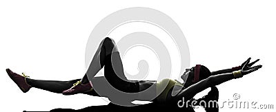 Woman exercising fitness stretching lying on back silhouette Stock Photo