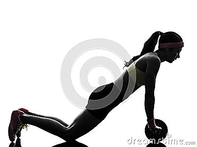 woman exercising fitness workout abdominal toning wheel silhouette Stock Photo