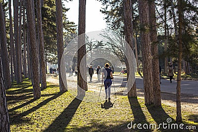 Woman exercising in park in Paris. Nordic walking in spring nature Editorial Stock Photo