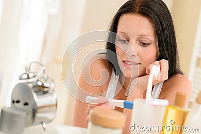 Woman expecting pregnancy test result in bathroom Stock Photo