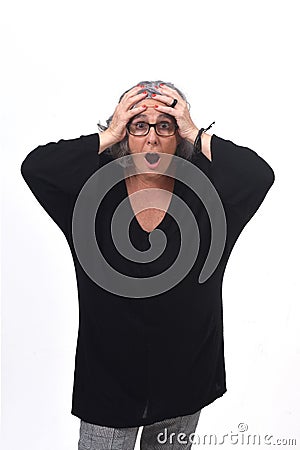 Woman with expression of forgetfulness or surprise on white background Stock Photo