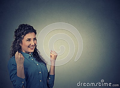 Woman exults pumping fists celebrates success. Positive human emotions Stock Photo