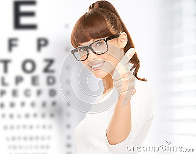 Woman in eyeglasses with eye chart Stock Photo