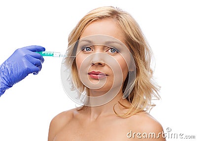 Woman face and beautician hand with syringe Stock Photo