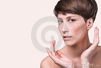 Woman face covered with cracked earth texture- symbol of dry skin Stock Photo