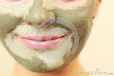 Woman face with green clay mud mask Stock Photo
