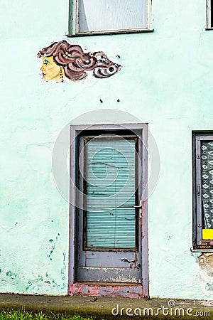 Woman faces on a house wall Stock Photo