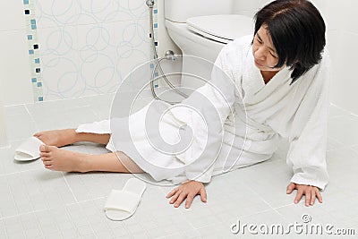 Woman falling in bathroom Stock Photo