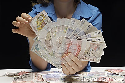 Woman With Fan Of Pound Currency Notes Editorial Stock Photo