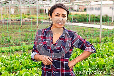 woman farmer smiling at vegetable plant factory Stock Photo