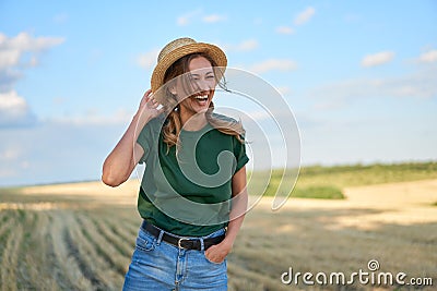 Woman farmer straw hat standing farmland smiling Female agronomist specialist farming agribusiness Happy positive caucasian worker Stock Photo