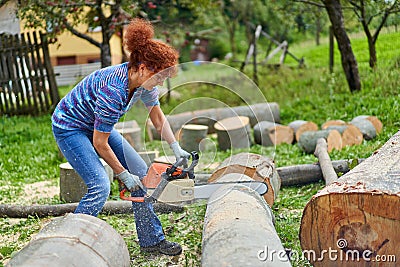 Woman farmer using the chainsaw Stock Photo