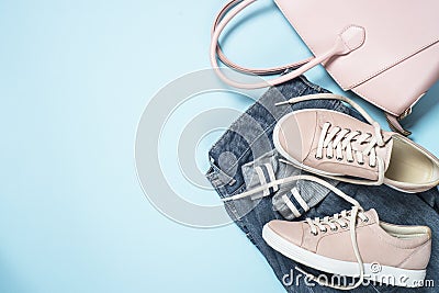Woman fashion cloth set pink shoes, jeans, handbag on blue backg Stock Photo