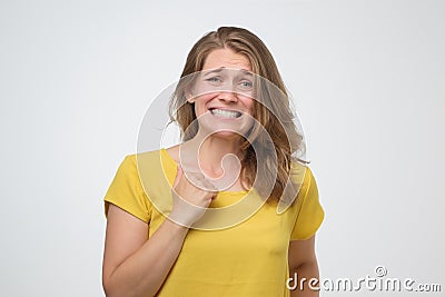 Woman feeling awkward, looking with weird smile after making mistake and being guilty Stock Photo