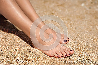 Woman feet on sand Stock Photo