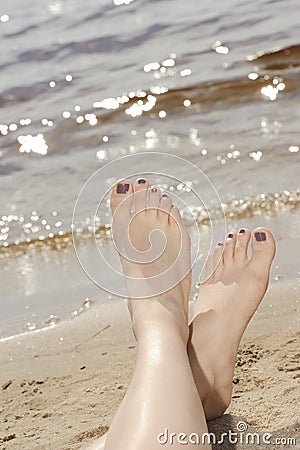 Woman feet in sand on the beach Stock Photo