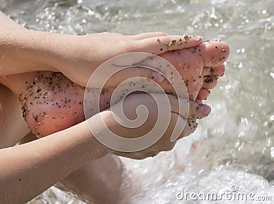 Woman feet in tiny rocks Stock Photo