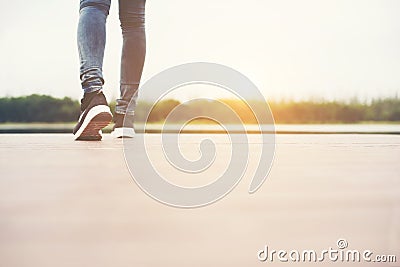 Woman feet walking on the wooden bridge, Alone. Stock Photo