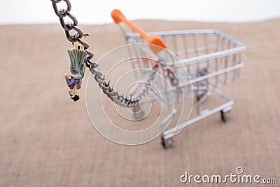 Woman figurine attached to a Shopping cart Stock Photo