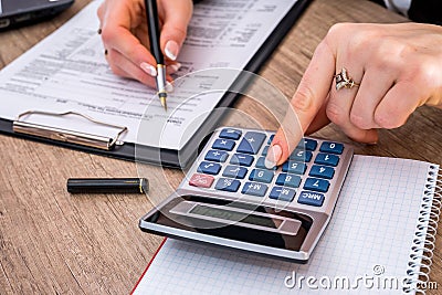 Woman filing individual income tax form 1040 Stock Photo