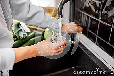 Filling drinking glass with tap water Stock Photo