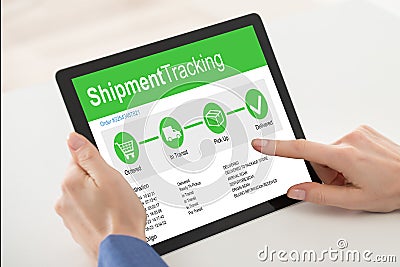 Customer Using Digital Tablet With Shipment Tracking Website Stock Photo