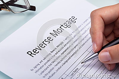 Woman Filling Reverse Mortgage Form Stock Photo