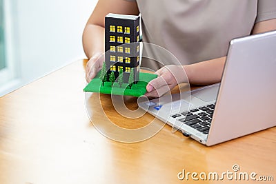 Woman fills out information on a computer to submit a condo loan at bank Stock Photo