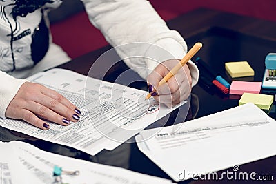 Woman fills the tax form, working with tax documents. Form 1040 Individual Income Tax return form. United States Tax forms. Editorial Stock Photo