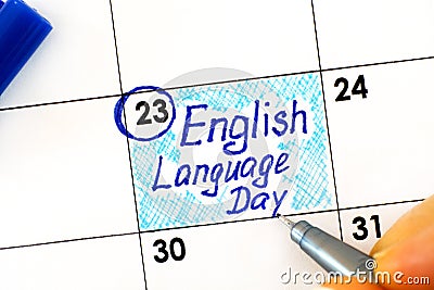 Woman fingers with pen writing reminder English Language Day in calendar Stock Photo