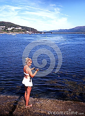 Woman fishing at Barmouth. Editorial Stock Photo