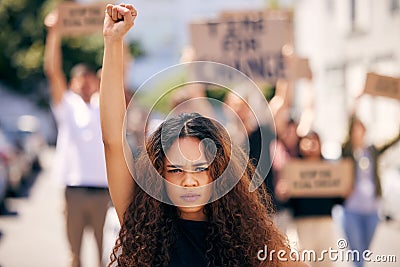 Woman, fist and portrait with protest crowd in street for planet, climate change or sustainable future. Girl, leadership Stock Photo