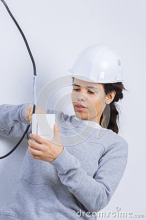 Woman fitting electrical outlet in bathroom Stock Photo