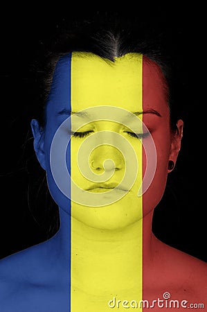 Woman with the flag of Rumania painted on her face. Stock Photo