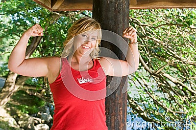 Woman flexing muscles Stock Photo