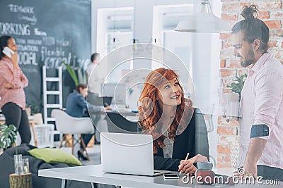 Woman flirting with coworker Stock Photo