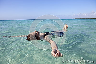 Woman floating in the sea Stock Photo