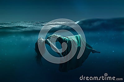 Woman floating under water Stock Photo
